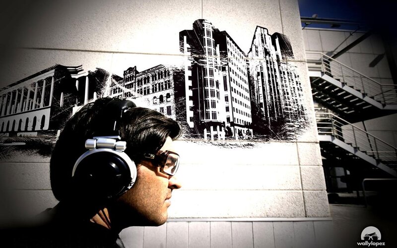 man with headphones near mural