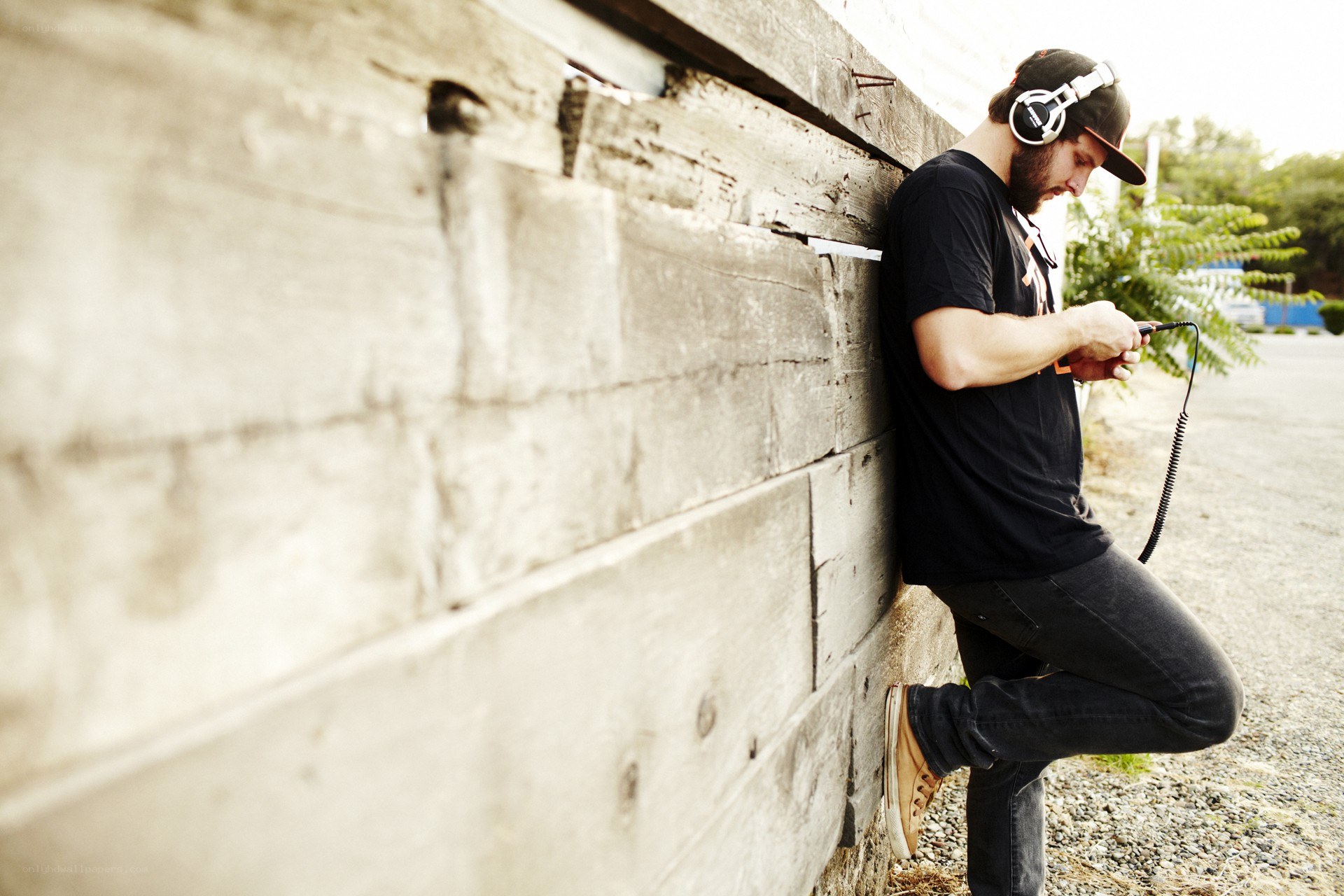 man with headphones on phone