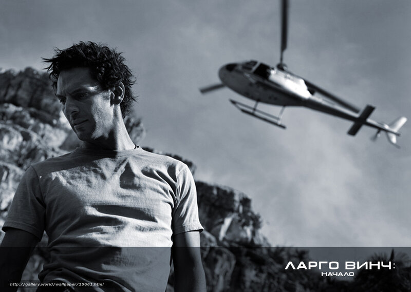 Man with helicopter in background