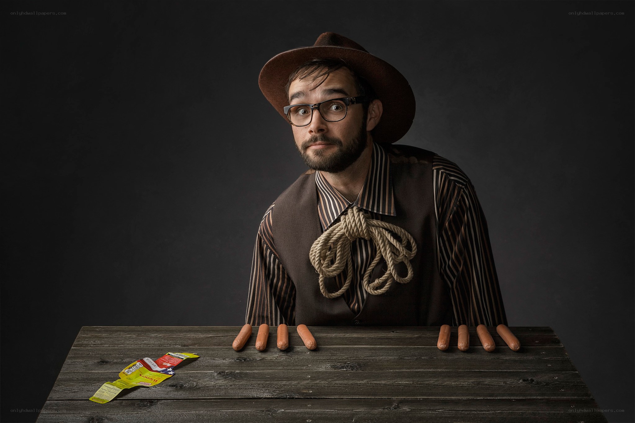 man with hot dogs on table