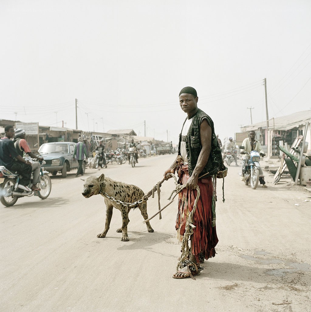 Man with hyena on a leash