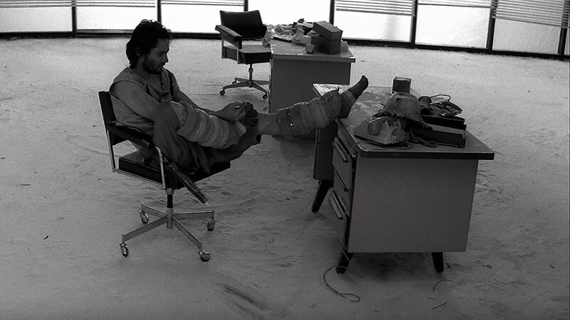 man with injured leg in office