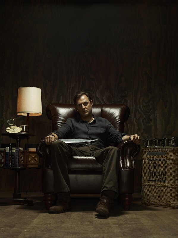 Man with knife in leather chair