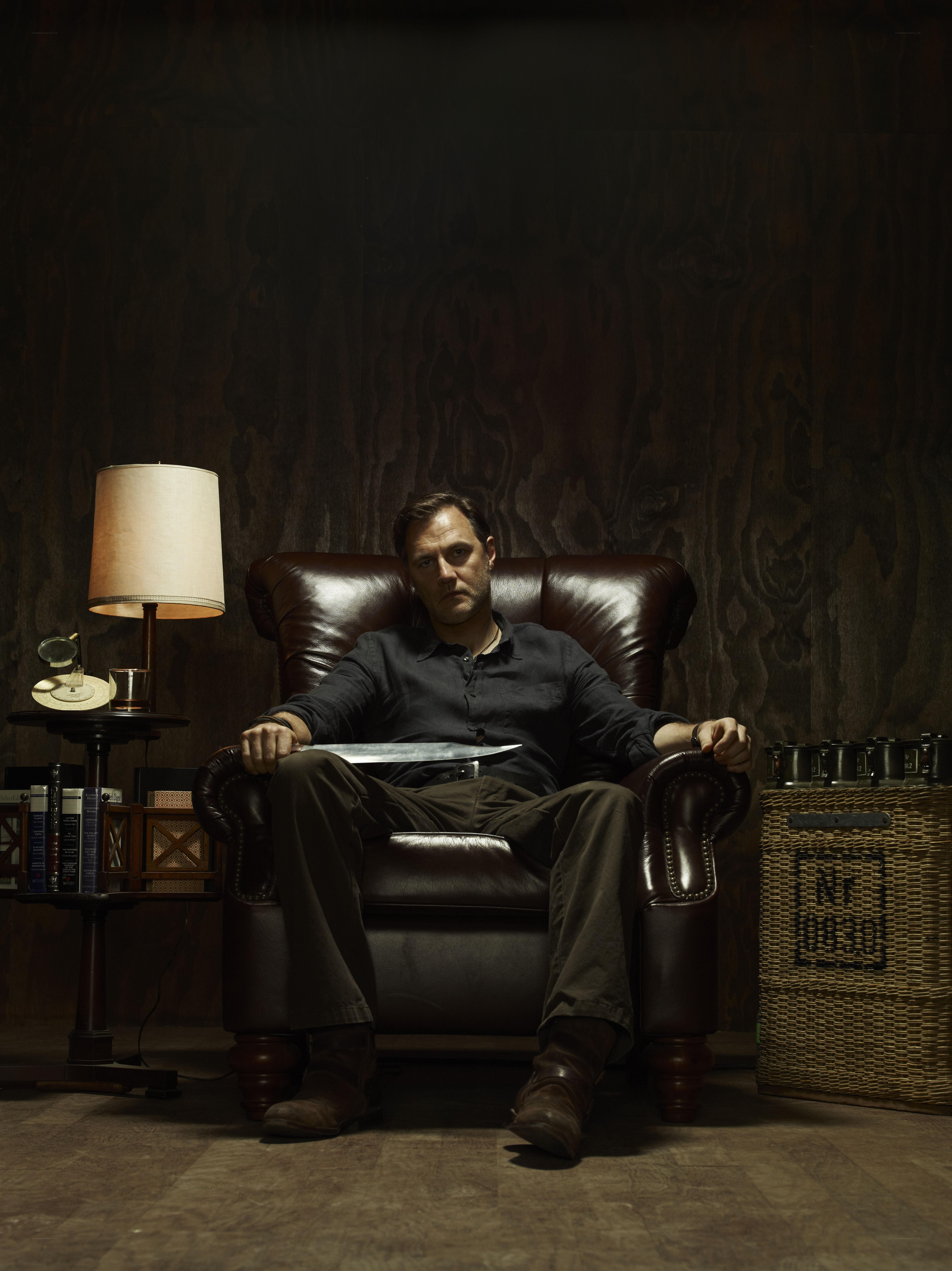 Man with knife in leather chair