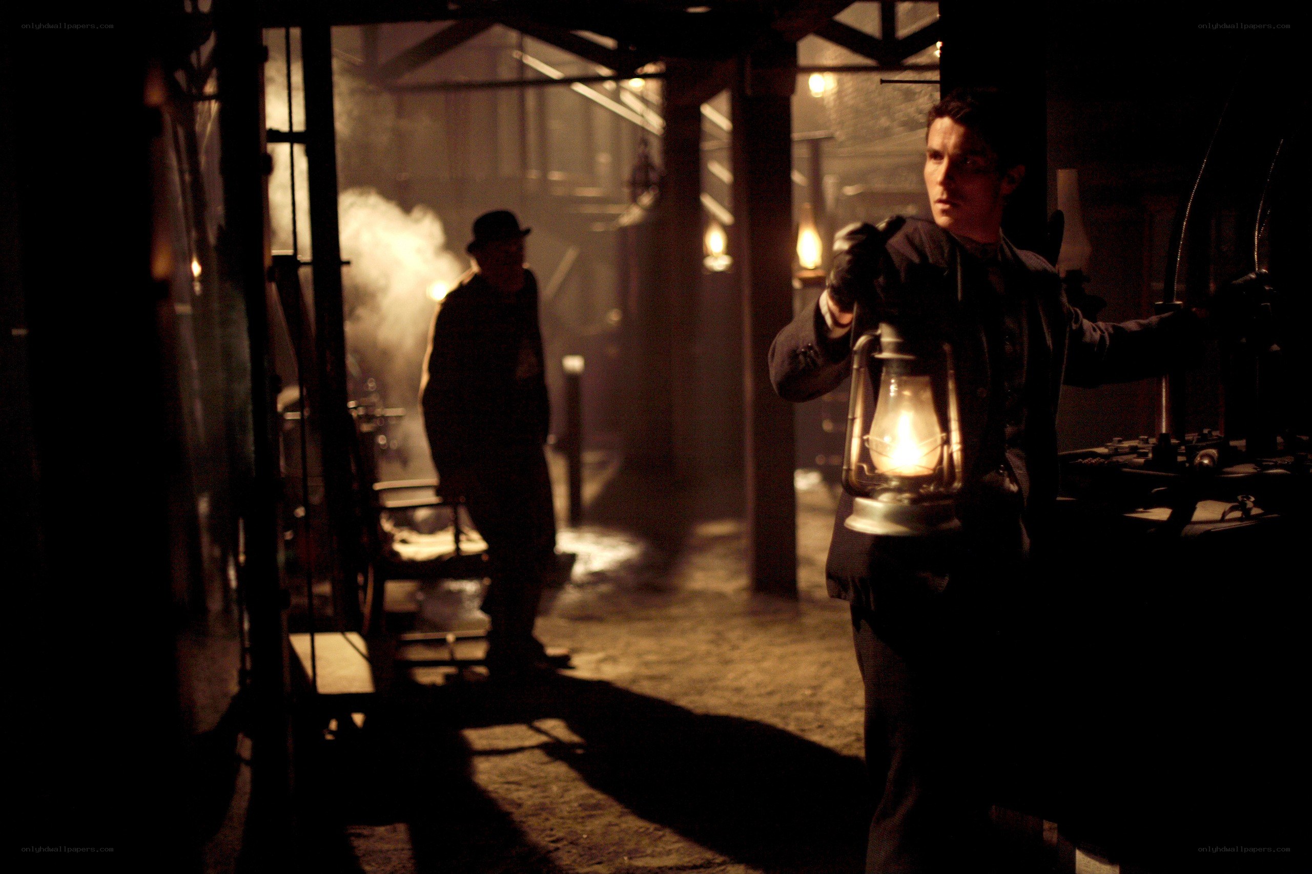 Man with lantern in dark room