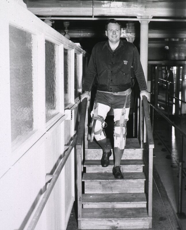 Man with leg braces on stairs
