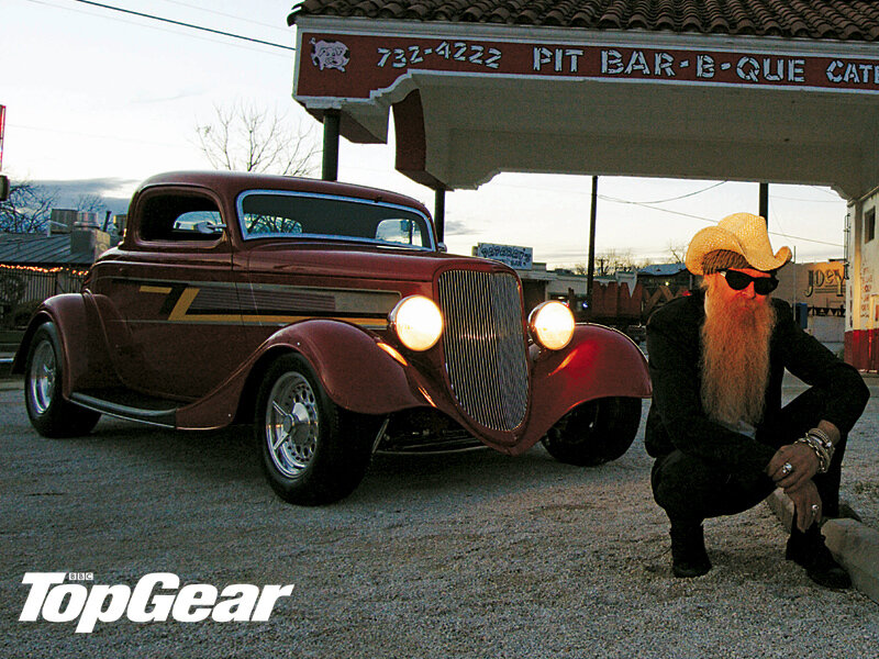 man with long beard and classic car