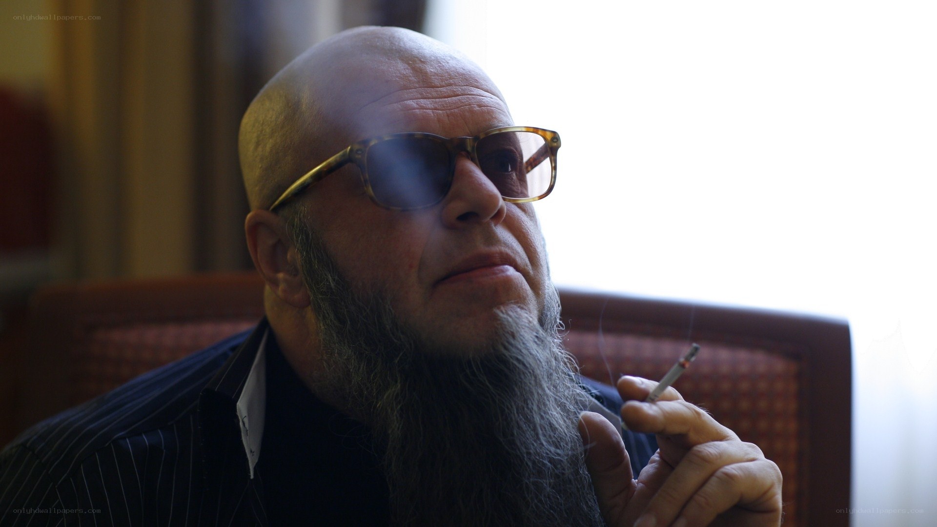 man with long beard smoking