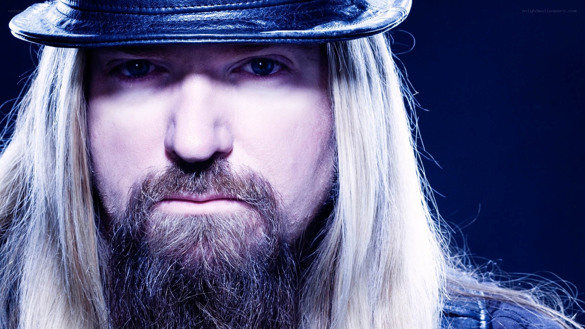 man with long hair and hat