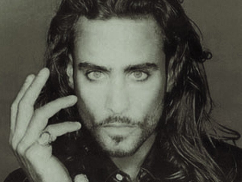 man with long hair and ring