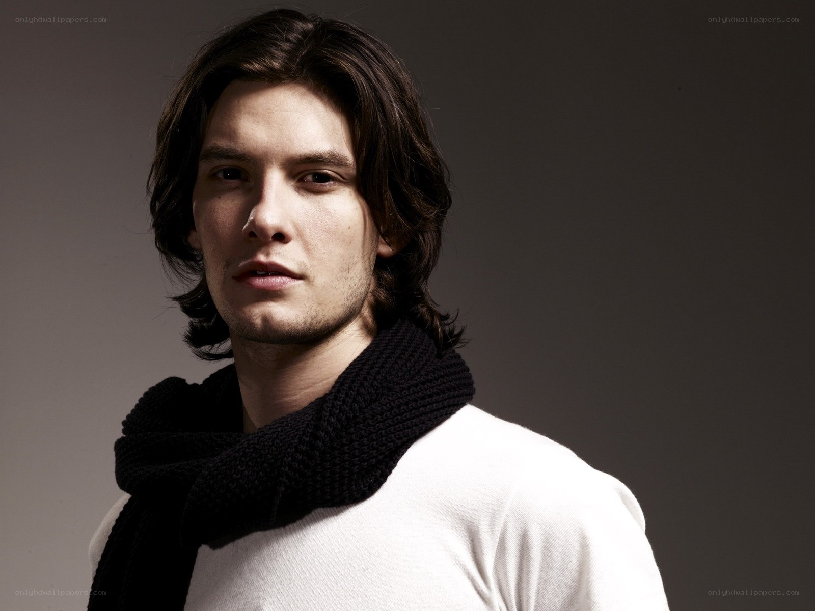 man with long hair and scarf
