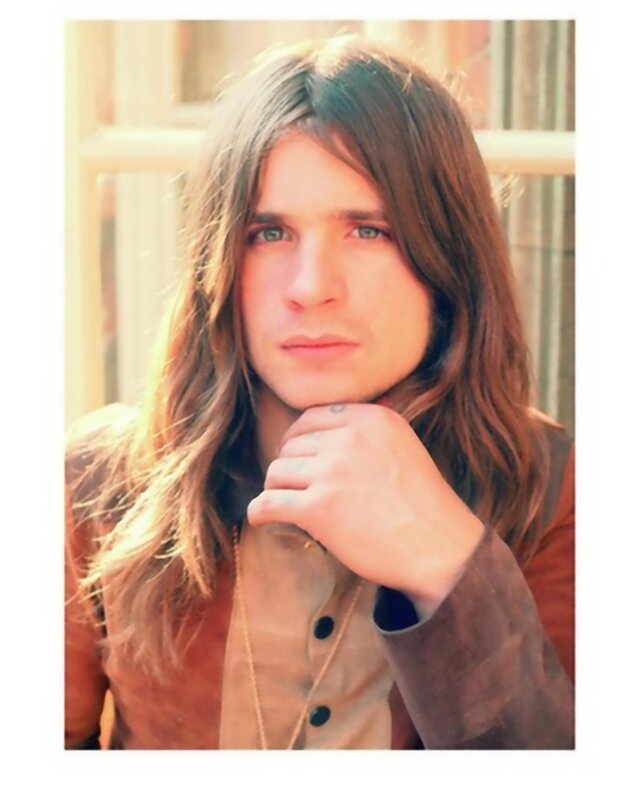 man with long hair and tattoos
