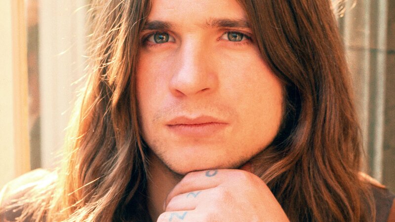 man with long hair and tattoos