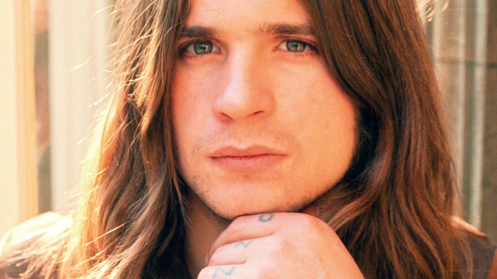man with long hair and tattoos