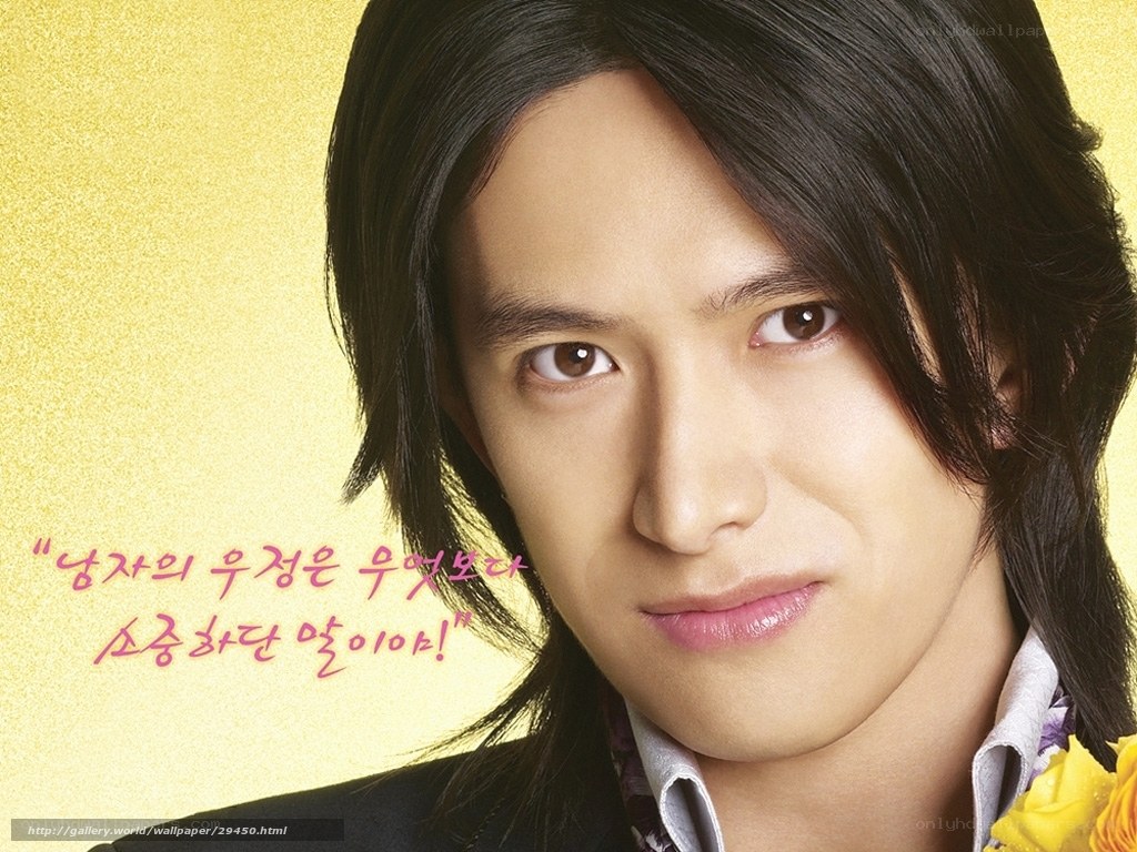man with long hair and yellow background