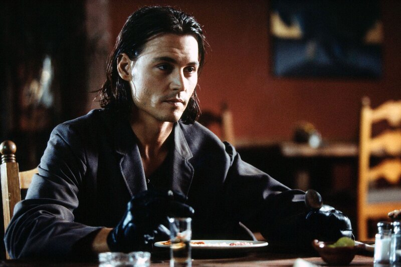 Man with Long Hair at Table — Black