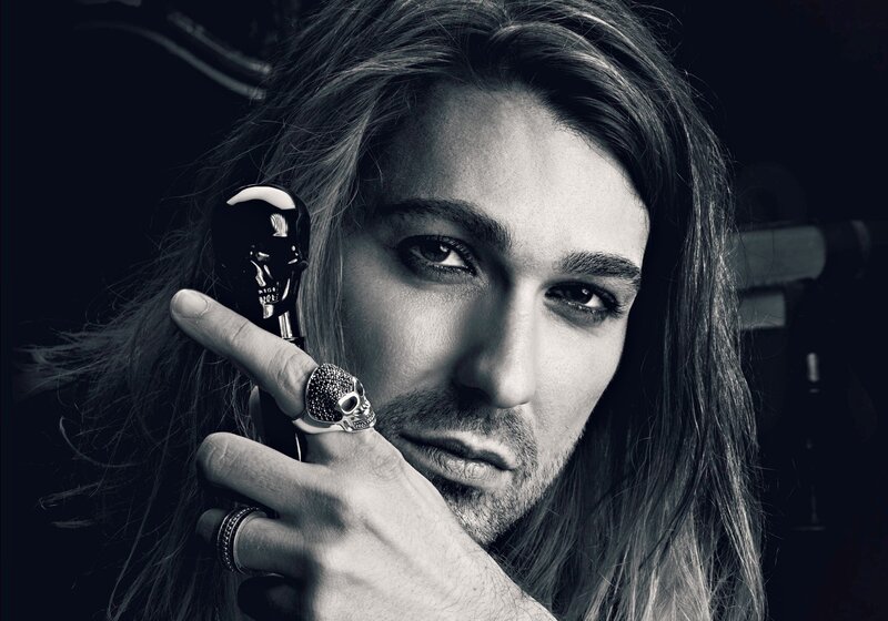 Man with Long Hair — Black, Dramatic, Photograph, Skull Ring, Perfume Bottle