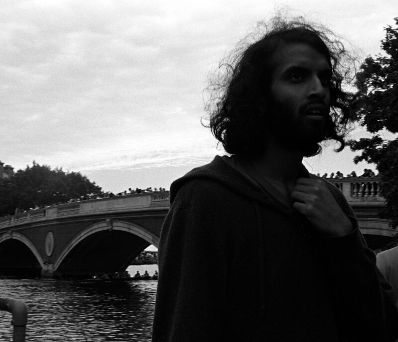 Man with long hair by a river