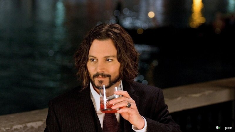 Man with Long Hair Holding Drink