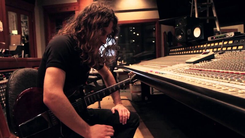 Man with Long Hair Holding Guitar — Black, Focused