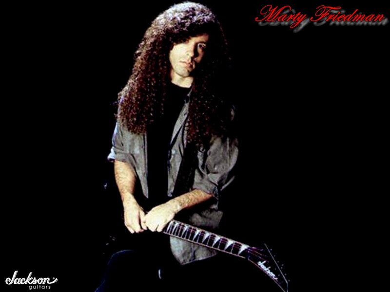 Man with Long Hair Holding Guitar