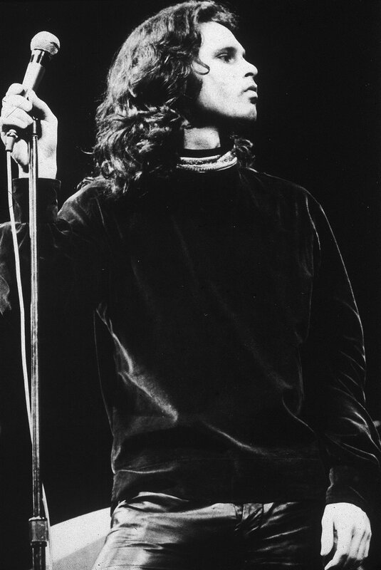 Man with long hair holding microphone