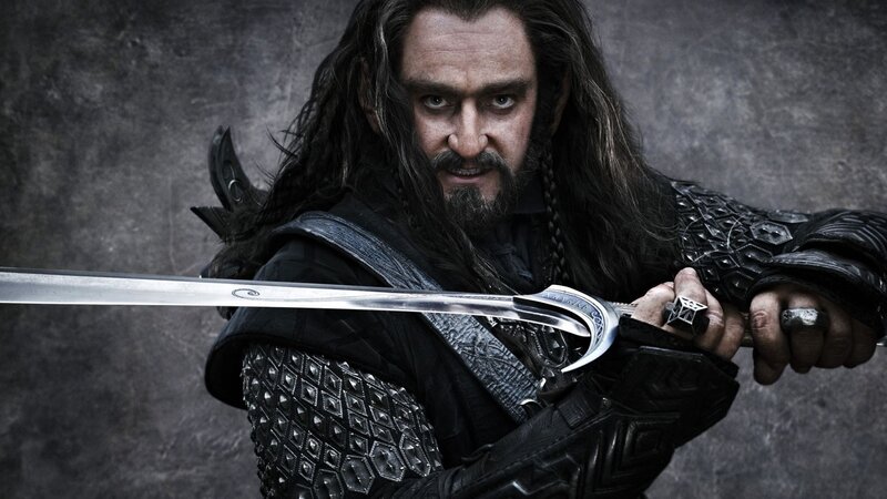 Man with Long Hair Holding Sword — Black, Dramatic, Photograph, Armor