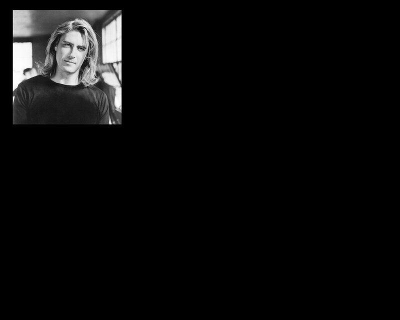 man with long hair in black and white