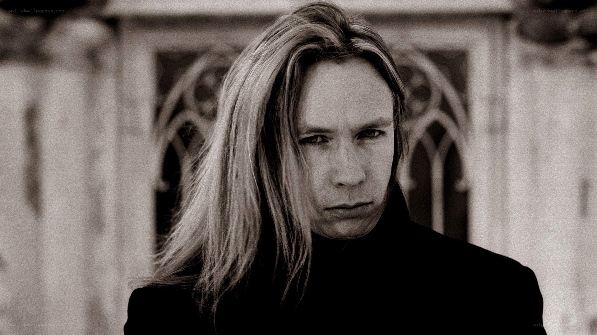 man with long hair in black and white