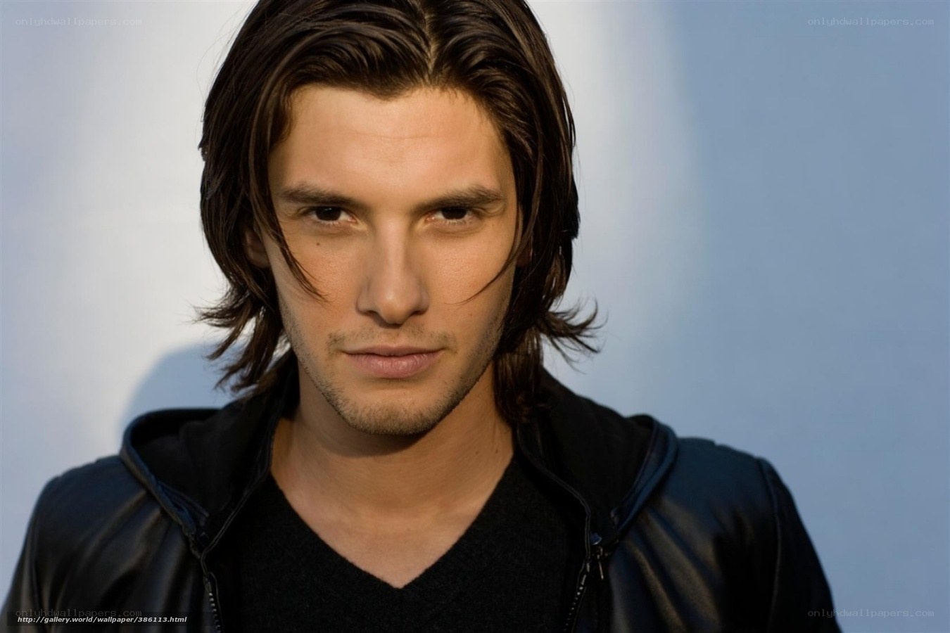 man with long hair in black jacket