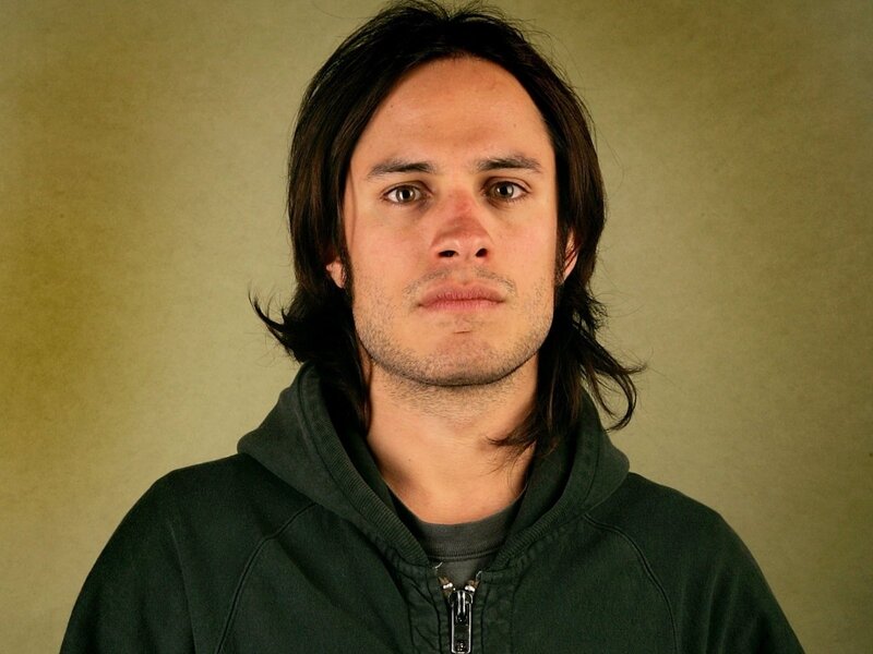man with long hair in hoodie