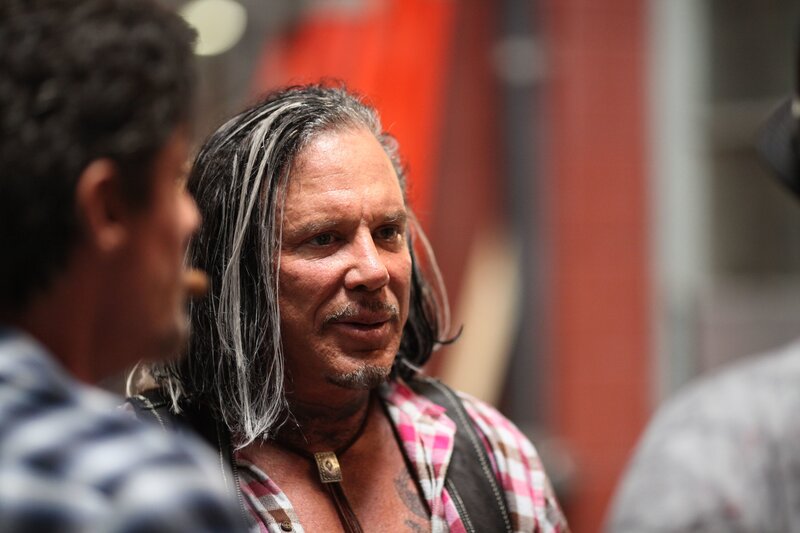 man with long hair in plaid shirt