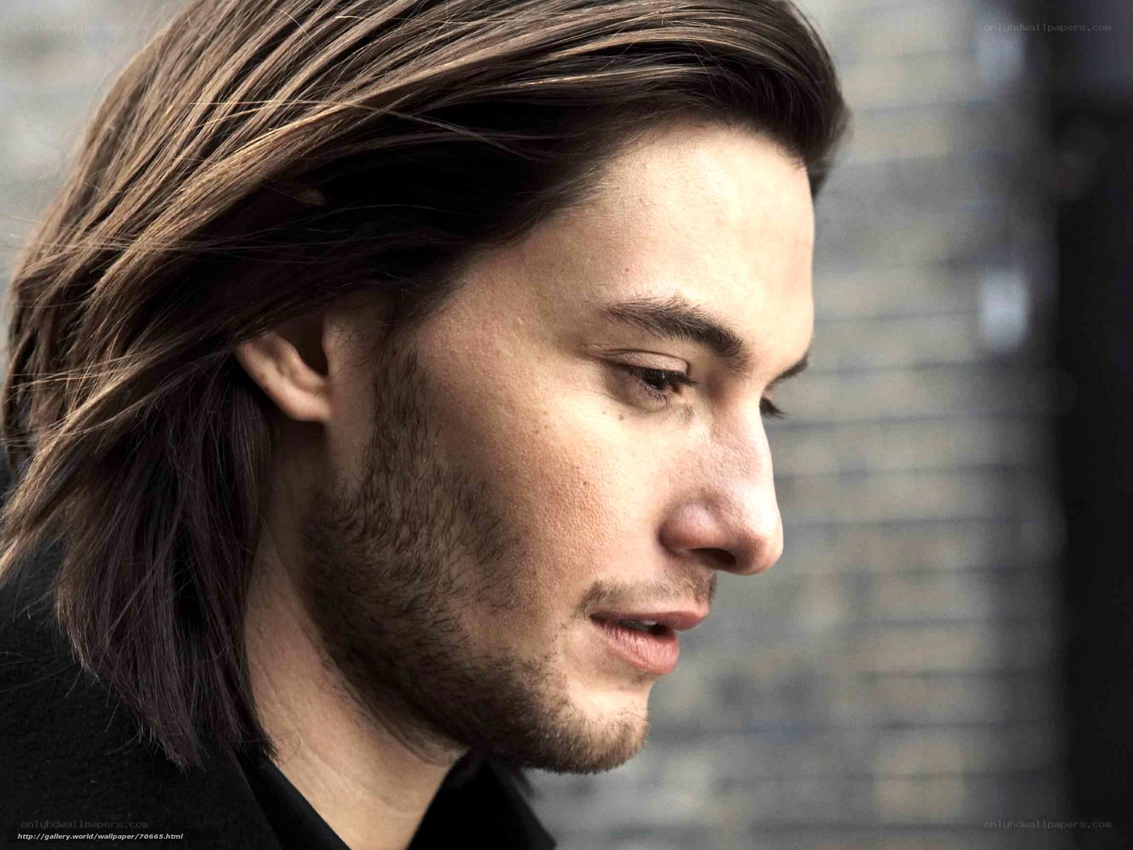 man with long hair in profile