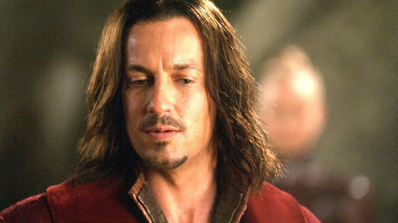 man with long hair in red jacket