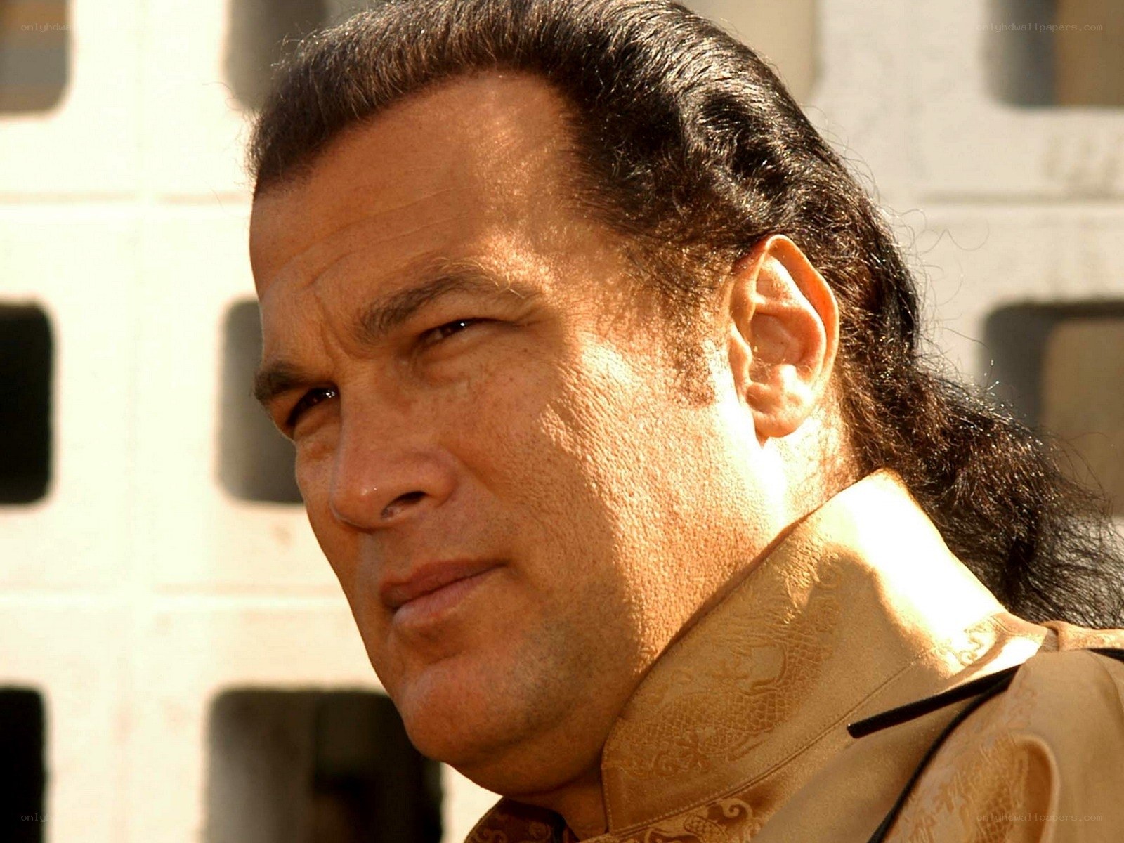 man with long hair in traditional attire