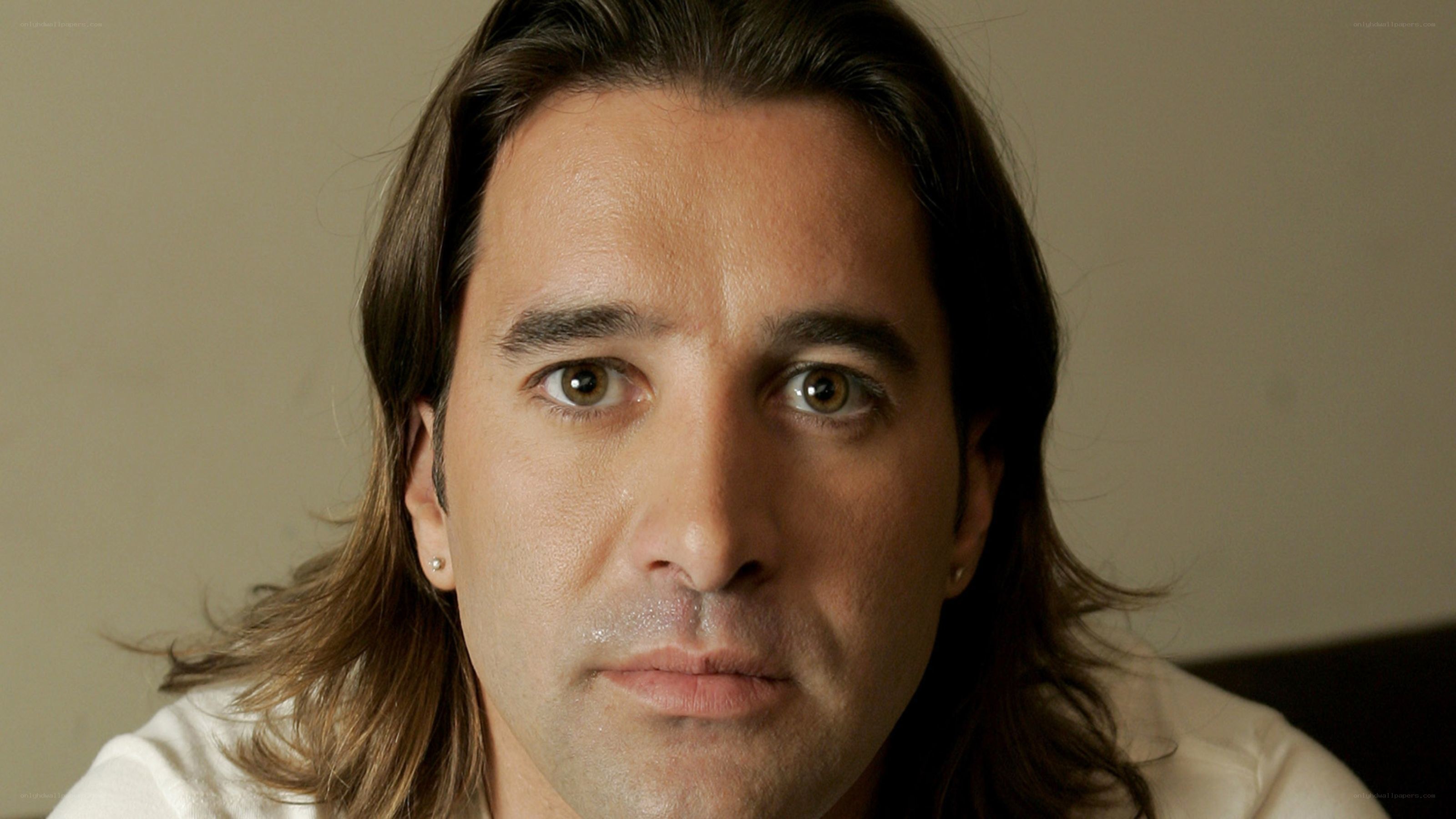 man with long hair looking at camera