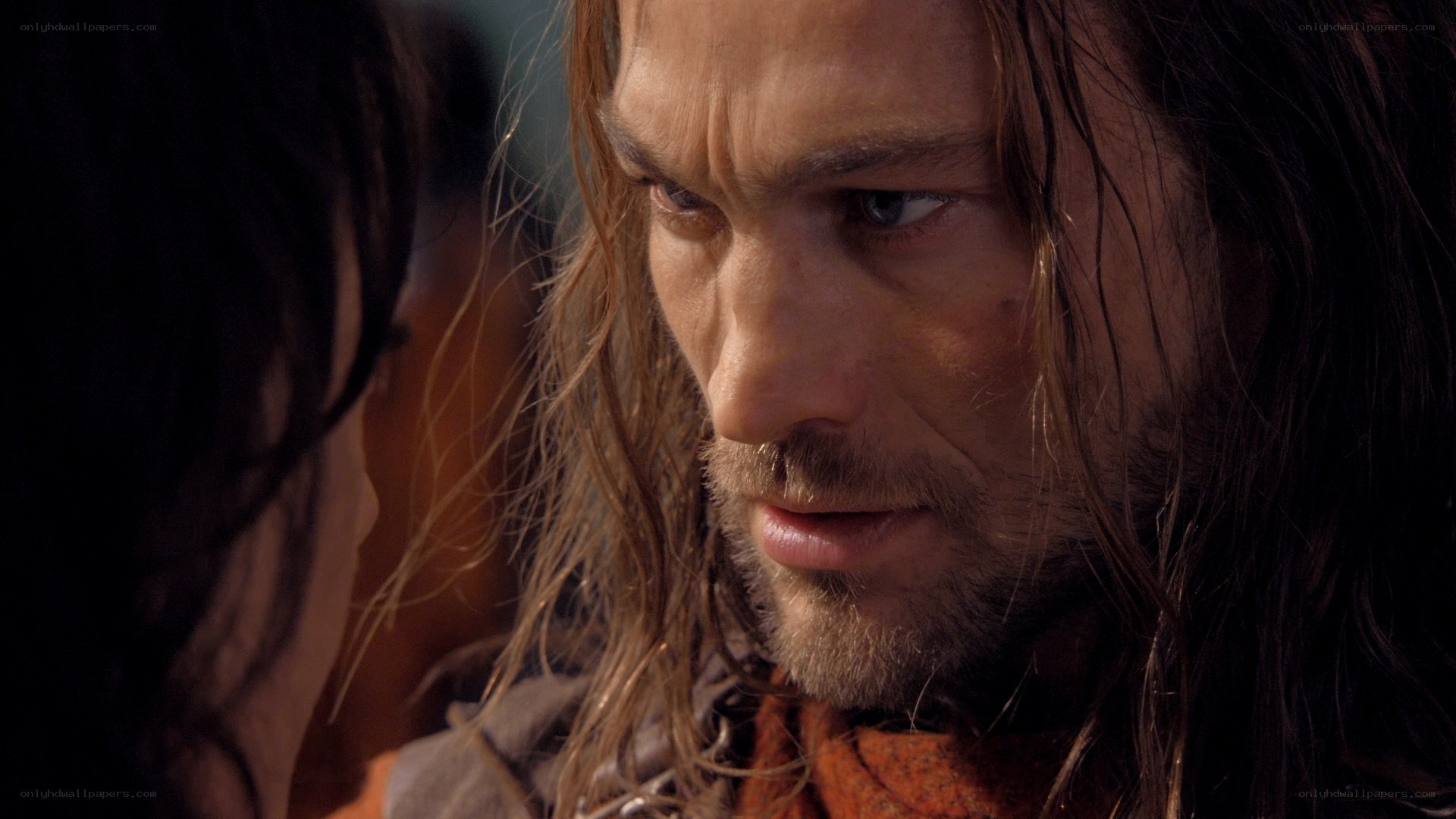 man with long hair looking at someone