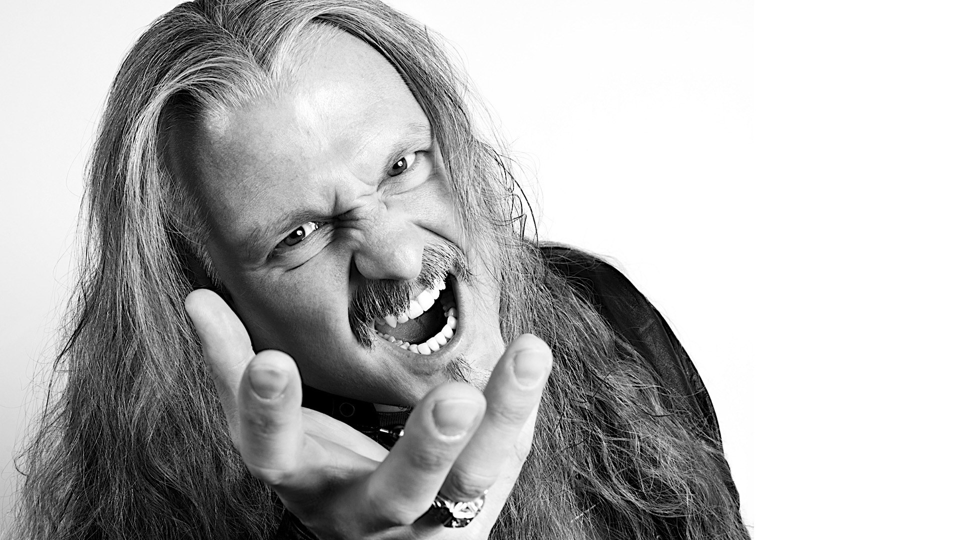man with long hair making a face
