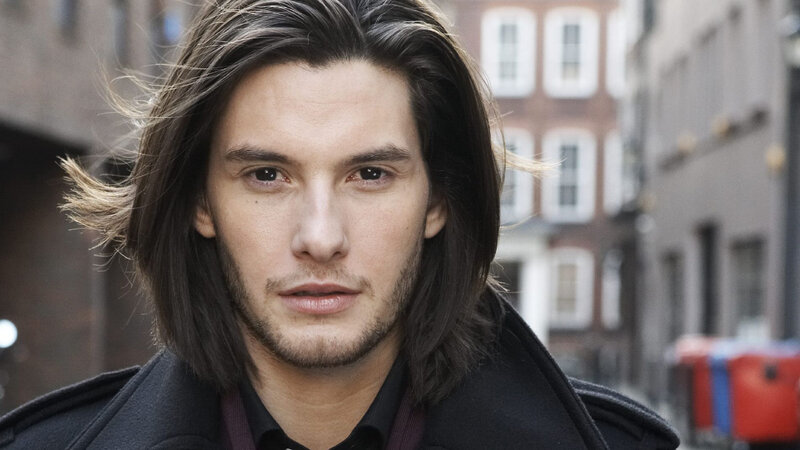 man with long hair on street