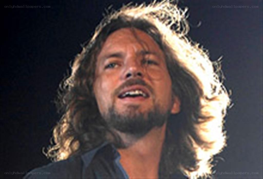 man with long hair singing