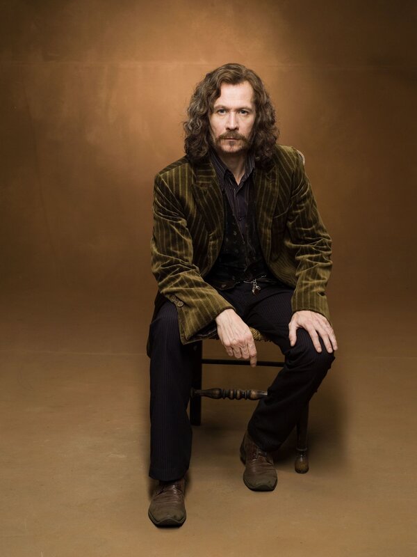 man with long hair sitting on chair