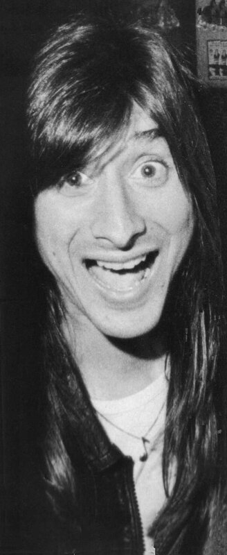 man with long hair smiling
