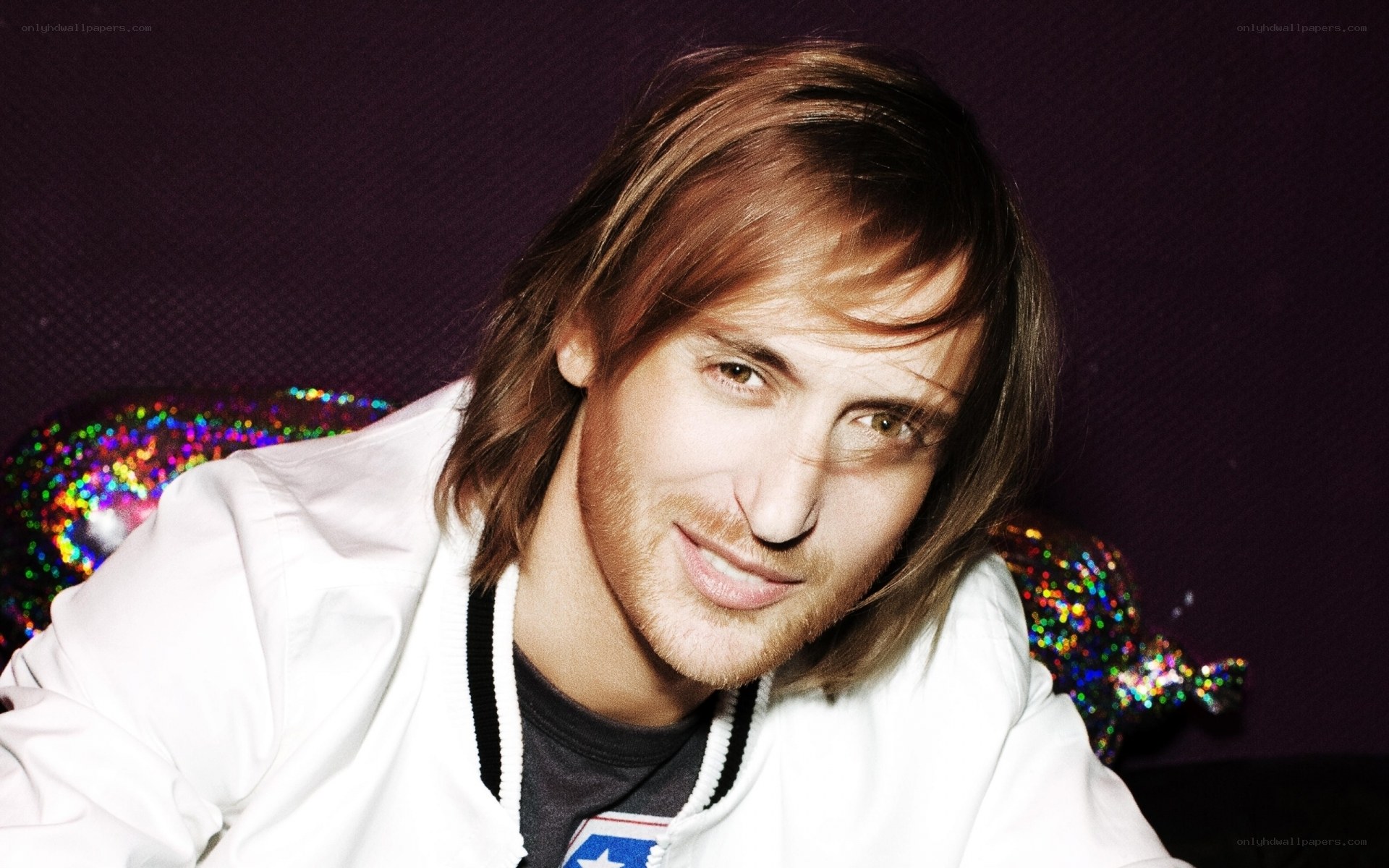 man with long hair smiling