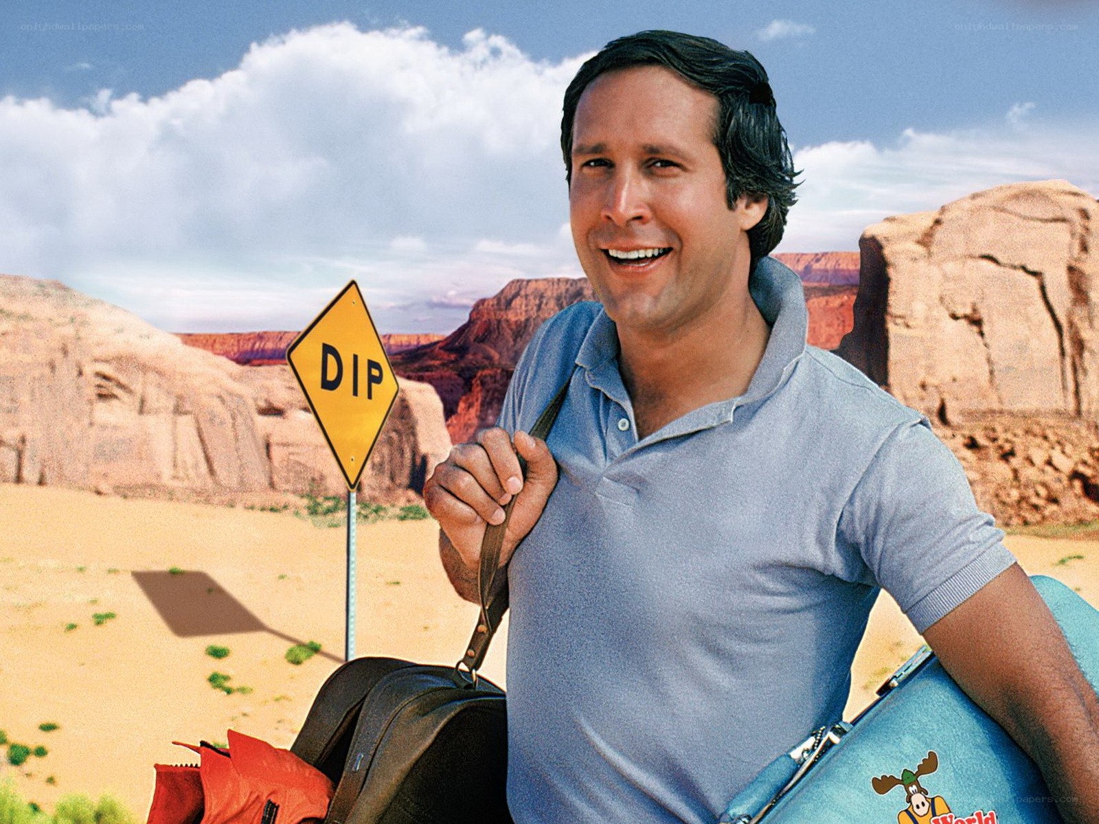 man with luggage in desert