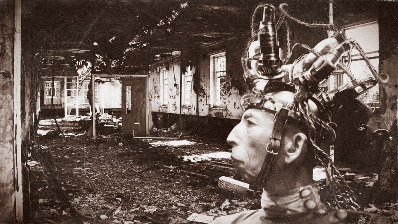 Man with mechanical head in ruin