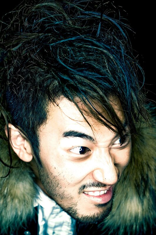 man with messy hair and fur coat