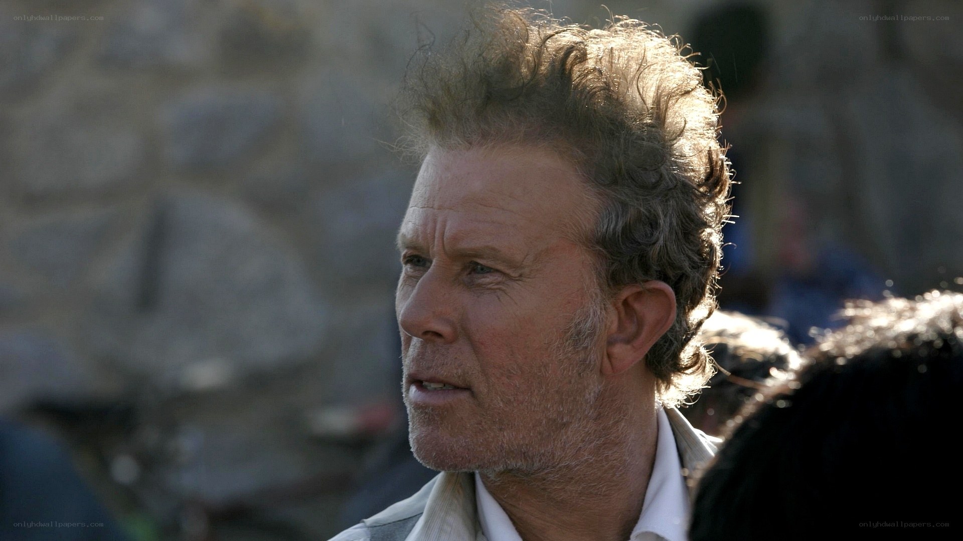 man with messy hair in sunlight