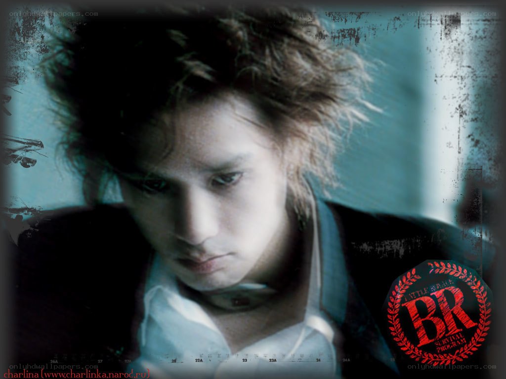 man with messy hair looking down