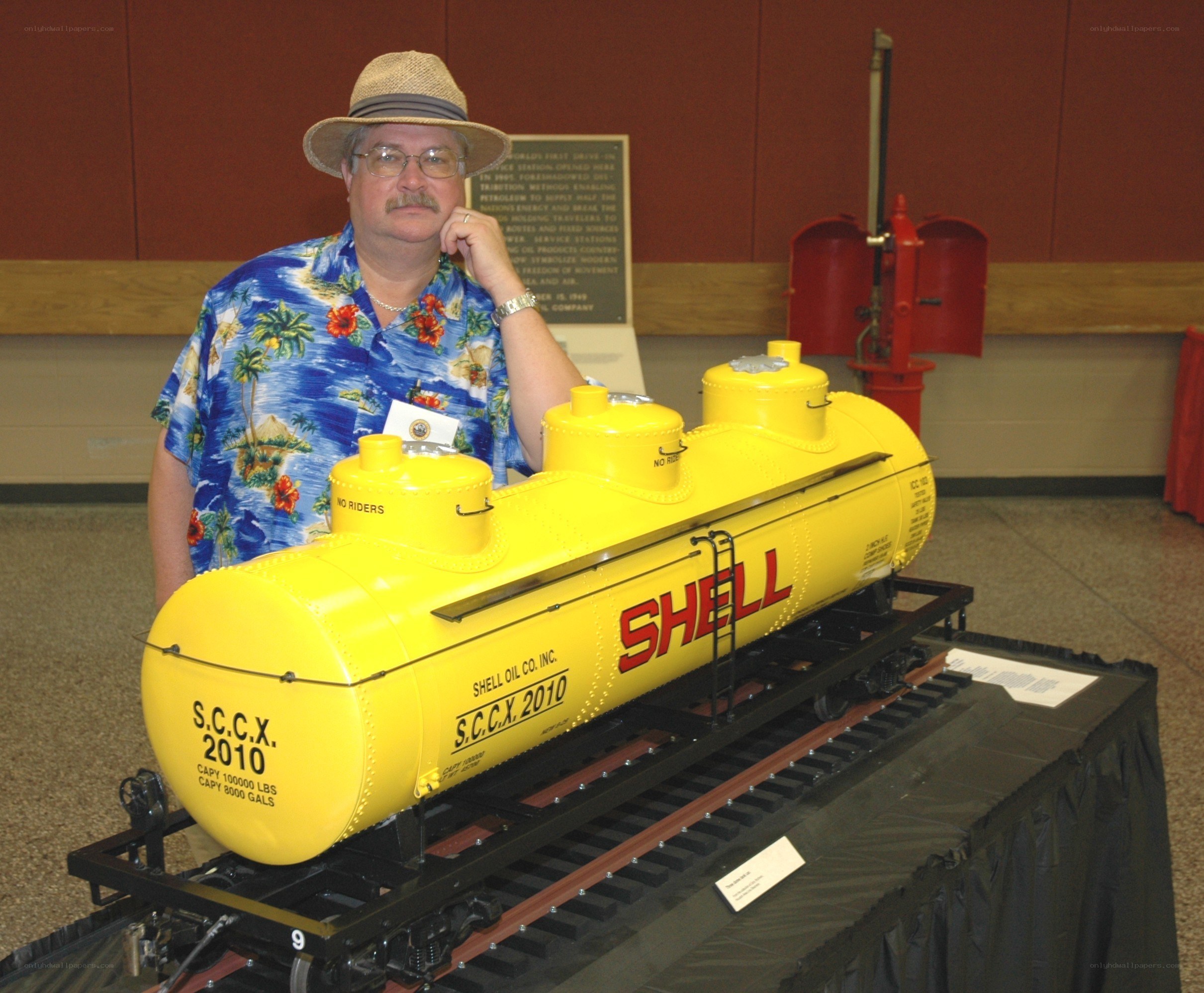Man with model train tank car