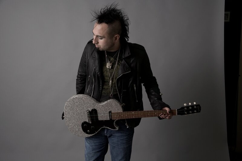 Man with Mohawk Holding Guitar